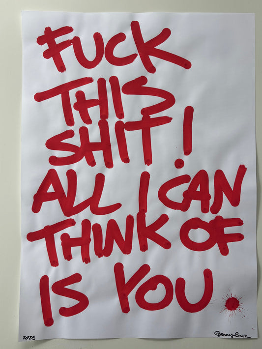 A white poster print featuring bold red handwritten-style text that reads, 'FUCK THIS SHIT! ALL I CAN THINK OF IS YOU,' with a small red splatter detail near the lower right. The poster is photographed against a light gray background.