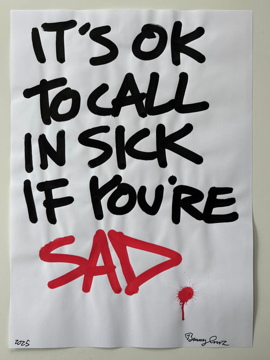 Handwritten text on a piece of paper with a red drawing, on a plain background.
