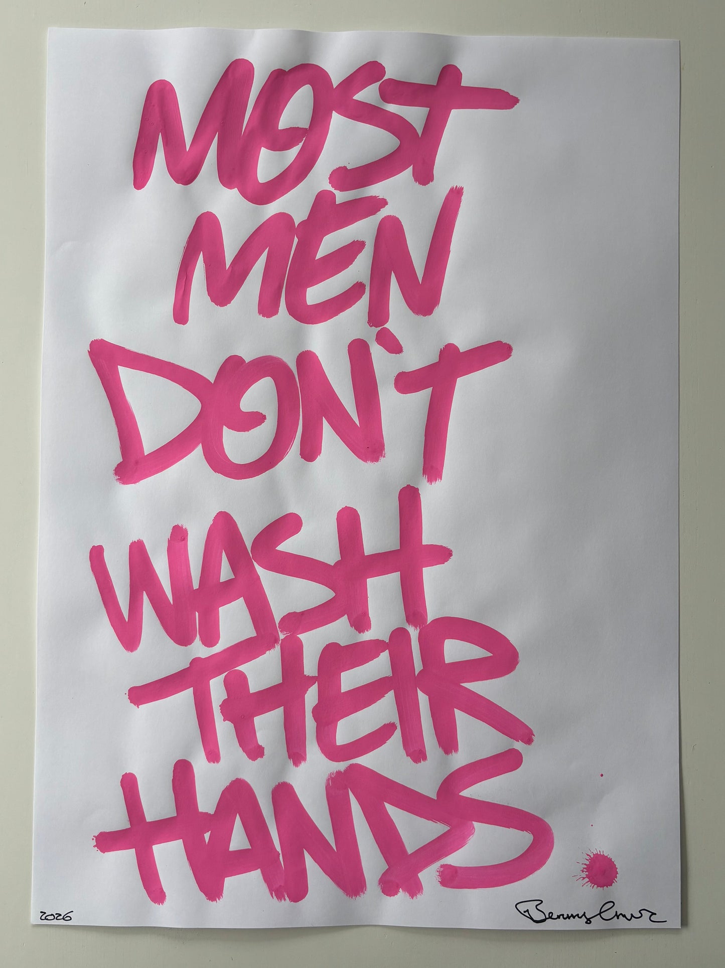 Sheet of paper with pink text on a plain background