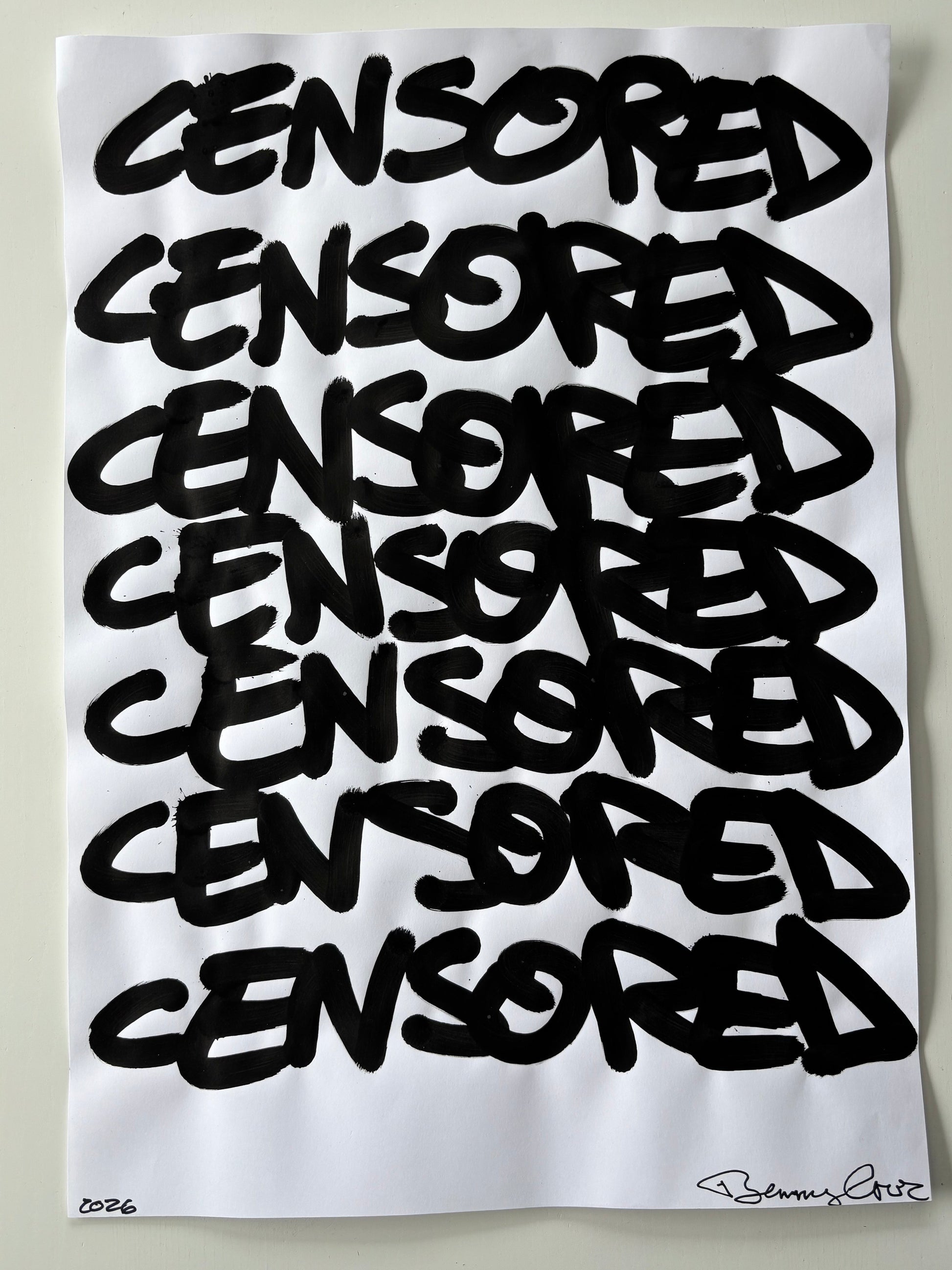 White pillow with black text spelling 'CENSORED' repeatedly