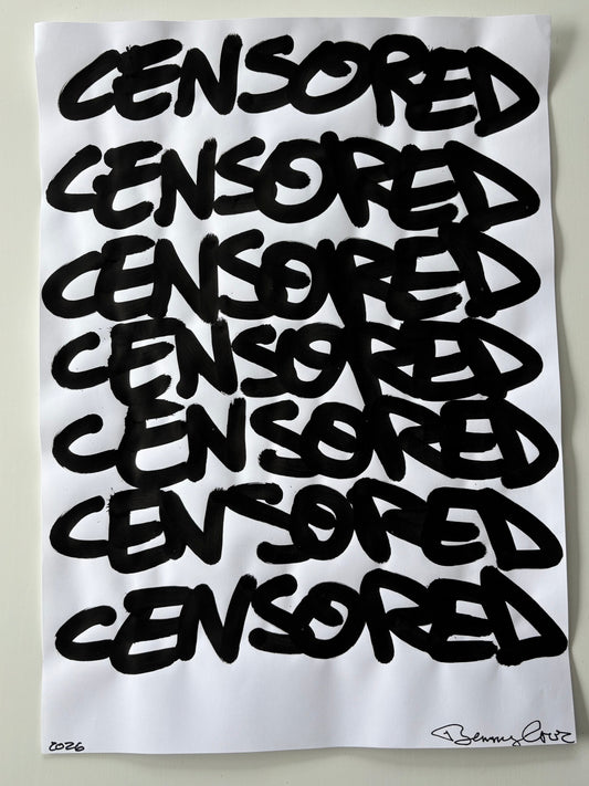 White pillow with black text spelling 'CENSORED' repeatedly